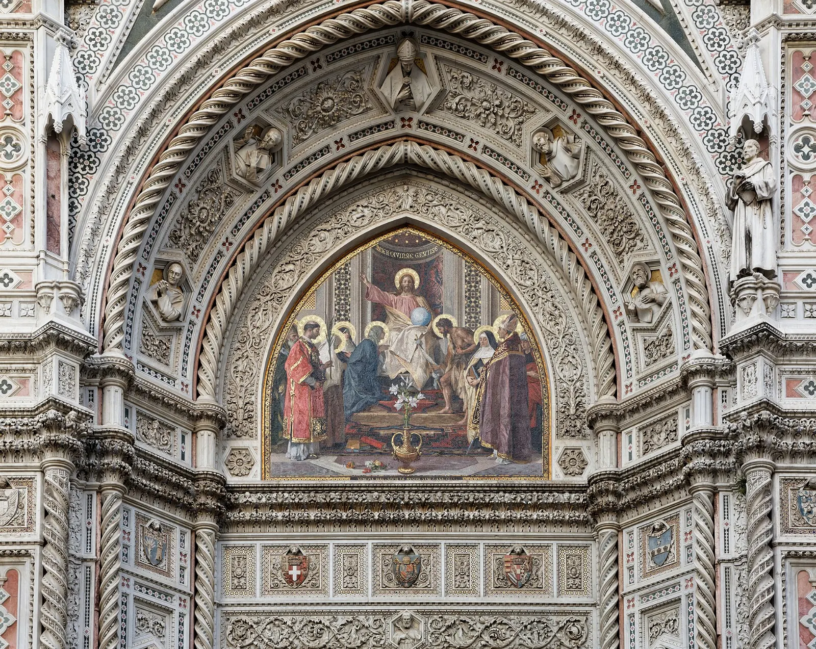 The white, green and pink marble facade of Florence Cathedral with Giotto's bell tower beside it, Italy