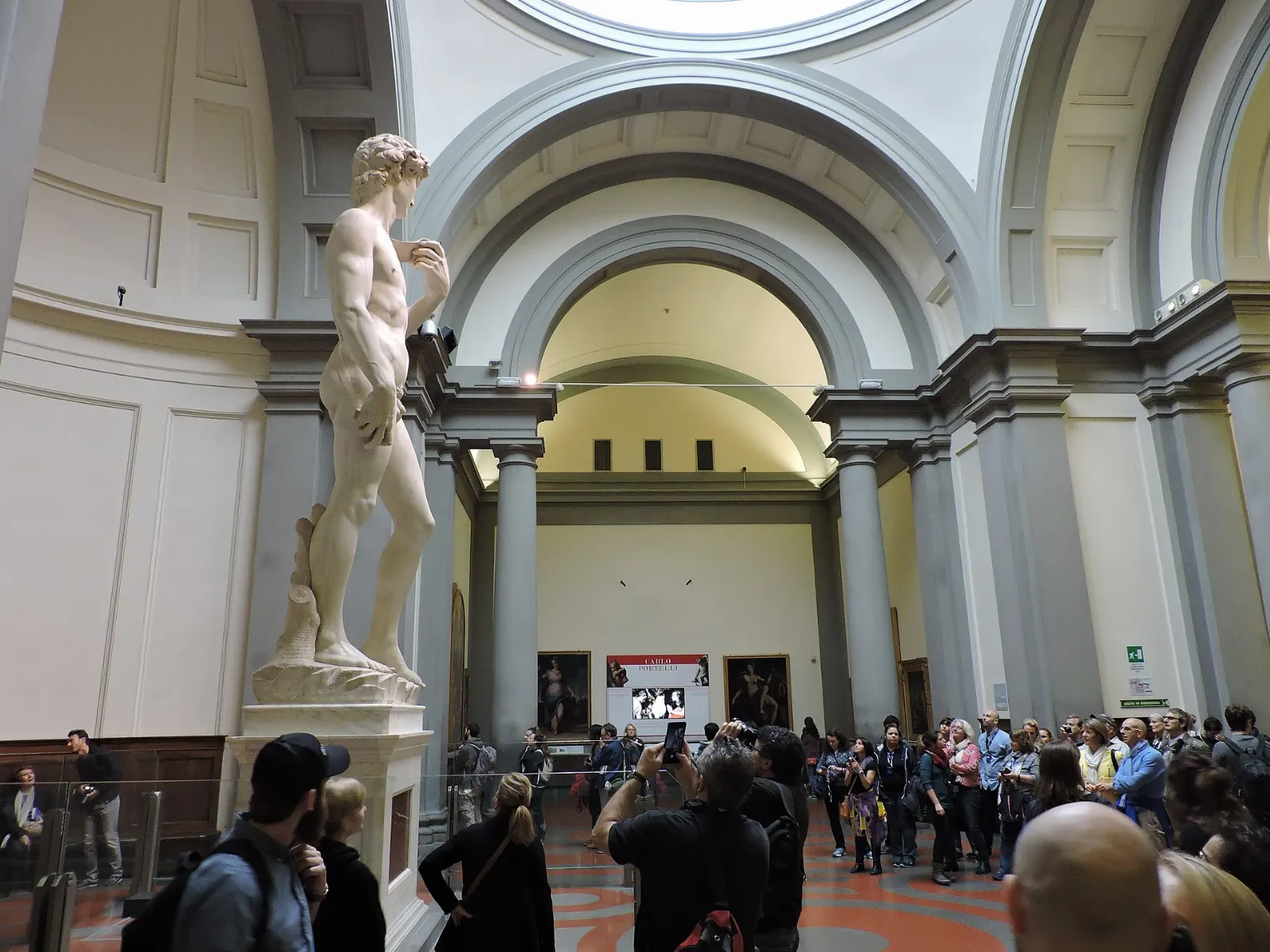 Michelangelo's marble statue of David under the skylit tribune at the Accademia, Florence, Italy