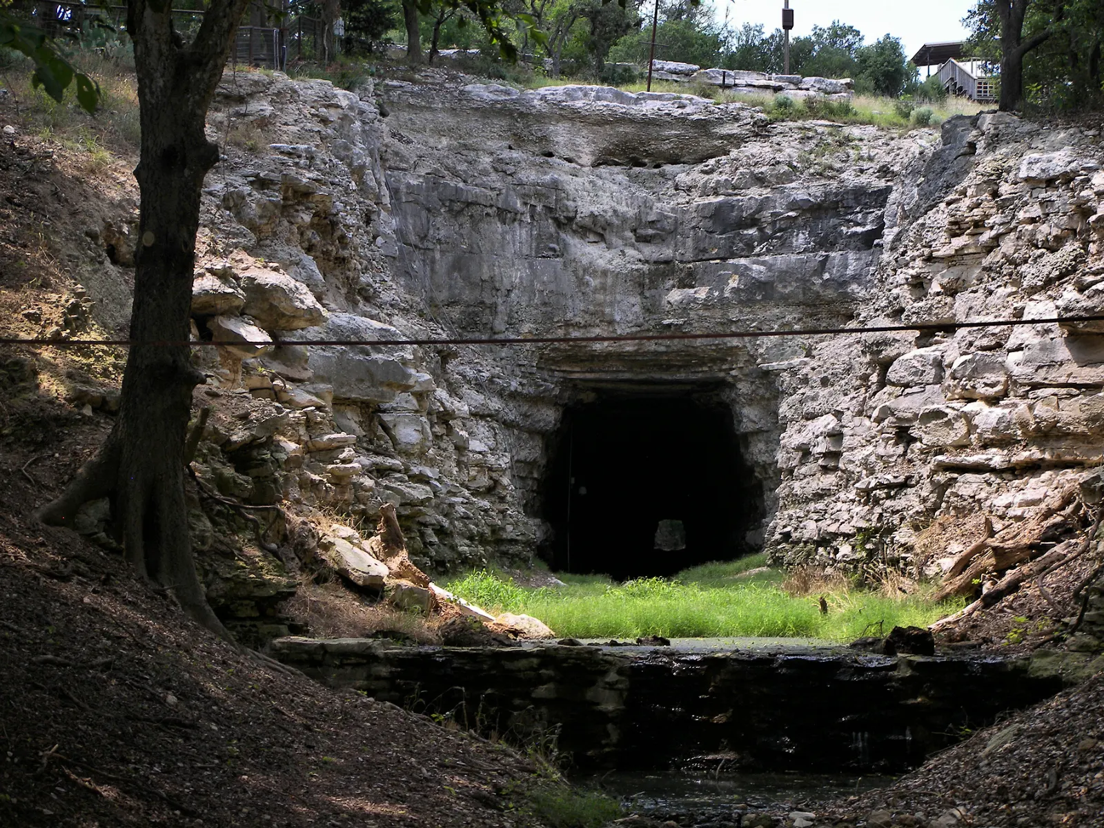 Entrance to an abandoned railroad tunnel in a limestone cut at Old Tunnel State Park, Fredericksburg, Texas
