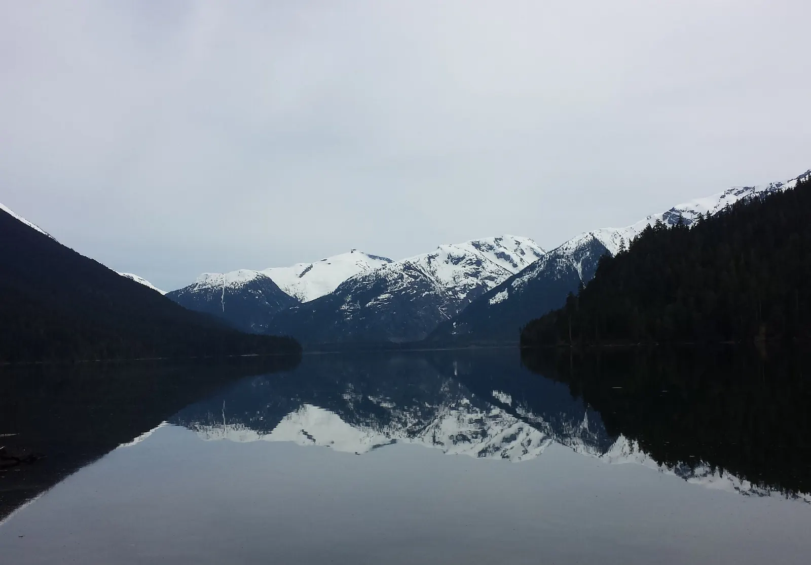 Calm green Cheakamus Lake surrounded by forested mountains, Garibaldi Provincial Park, British Columbia