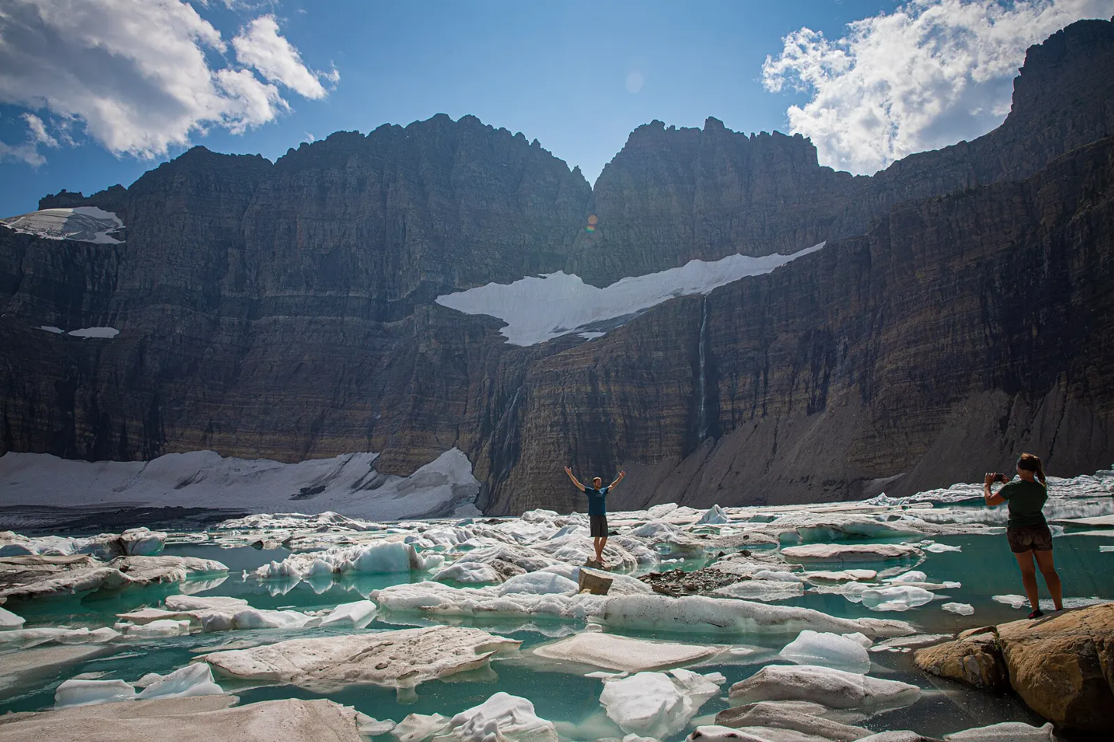 Icebergs floating in milky blue Upper Grinnell Lake below Grinnell Glacier, Glacier National Park, Montana