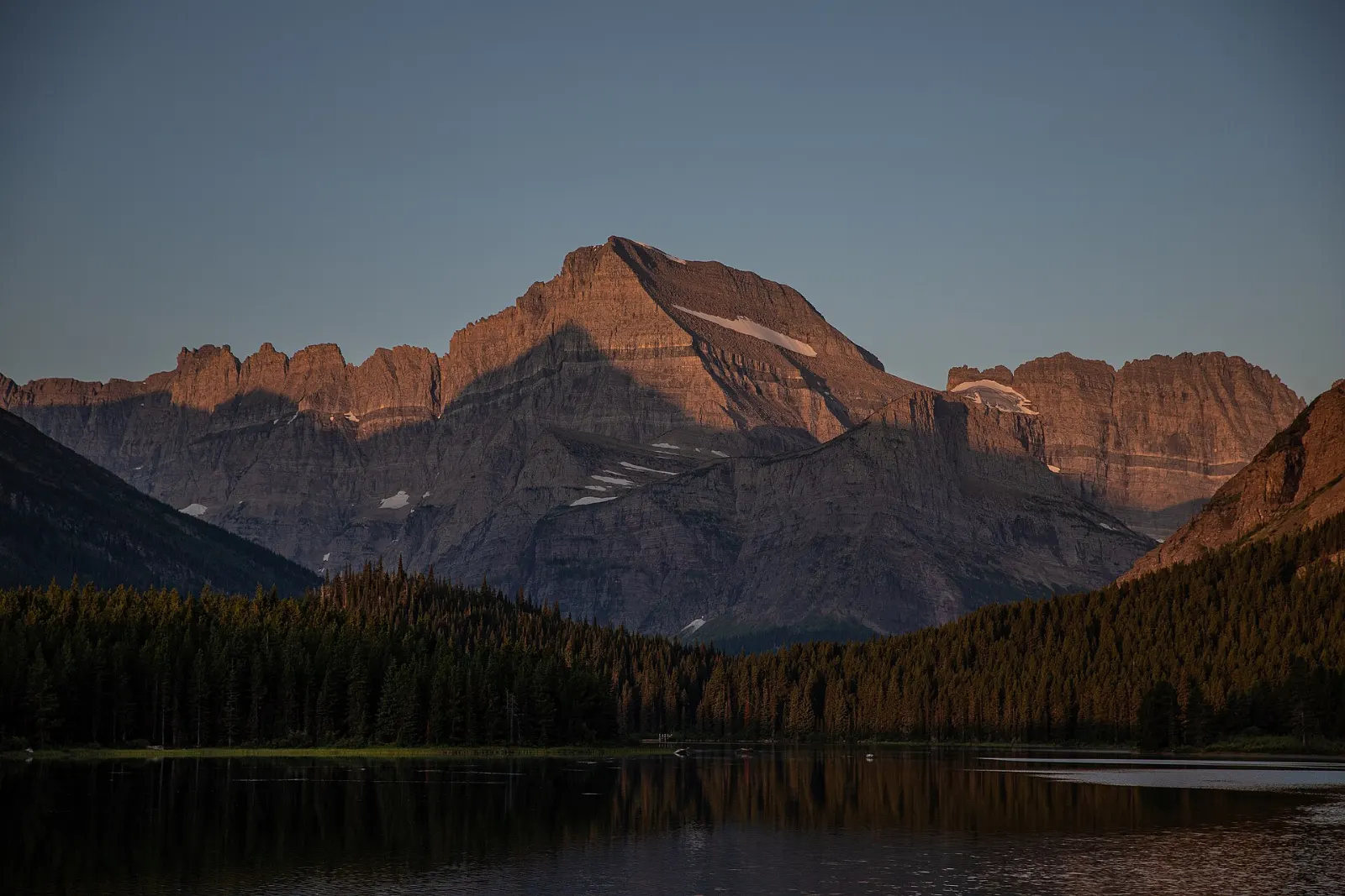 The Many Glacier Hotel on the shore of Swiftcurrent Lake with Grinnell Point behind, Glacier National Park, Montana