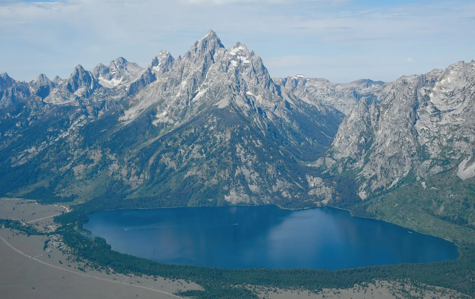 Clear blue water of Jenny Lake reflecting the steep peaks of the Teton Range, Grand Teton National Park, Wyoming