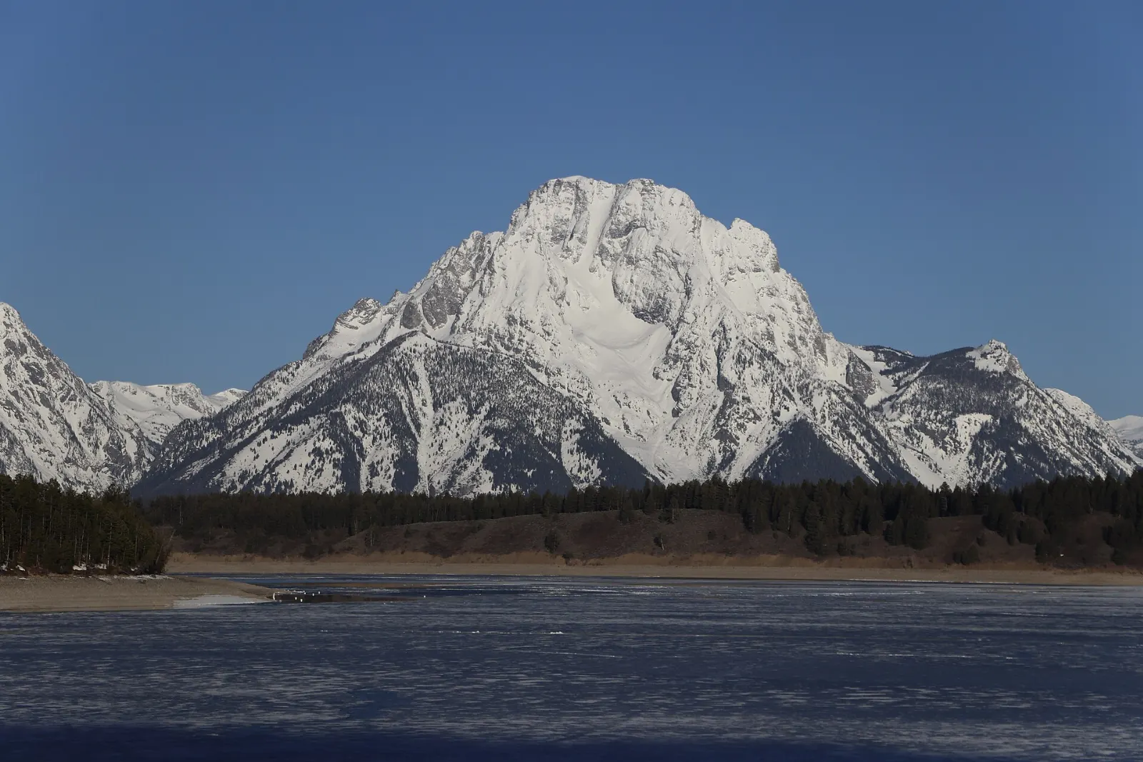 The broad surface of Jackson Lake with Mount Moran rising from its western shore, Grand Teton National Park, Wyoming
