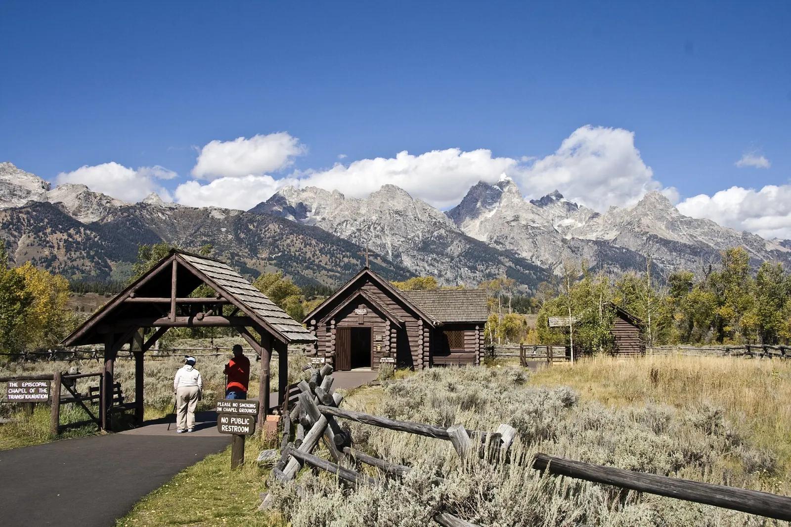 A small log chapel with a window framing the Teton Range, Grand Teton National Park, Wyoming