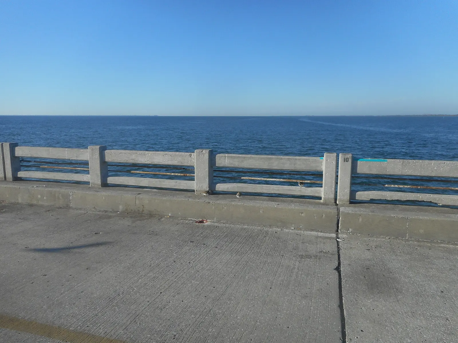 Long concrete fishing pier stretching into the Gulf at Gulf State Park, Gulf Shores, Alabama
