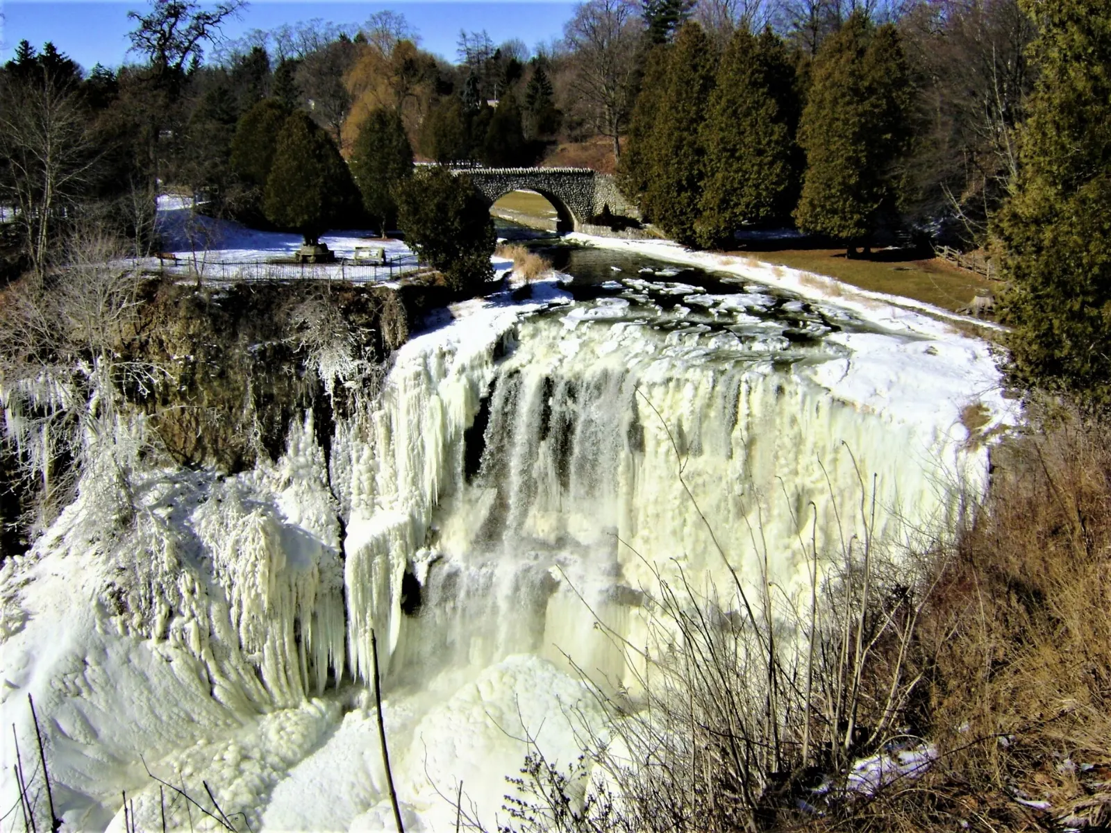 Water spreading across the wide curtain of Webster's Falls, Hamilton, Ontario