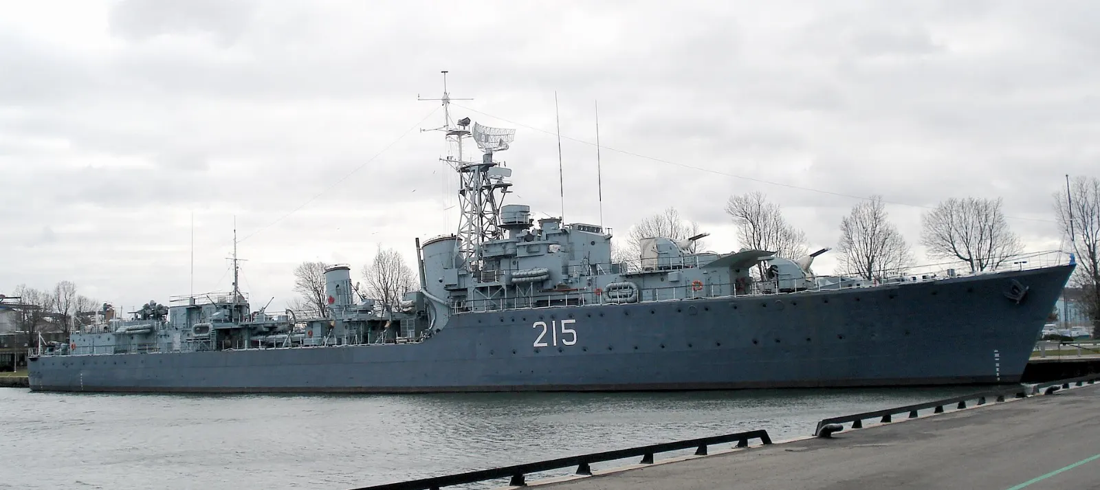 The grey hull and guns of HMCS Haida moored at Pier 9, Hamilton, Ontario