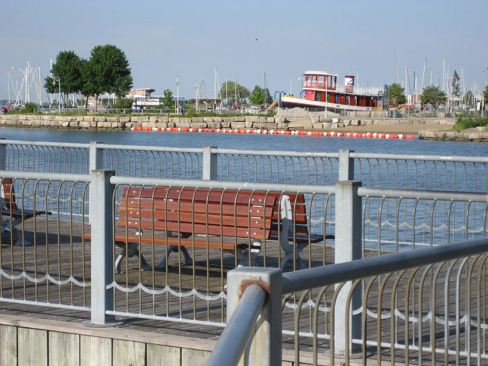 Boats and boardwalk along Hamilton Harbour at Pier 4 Park, Ontario