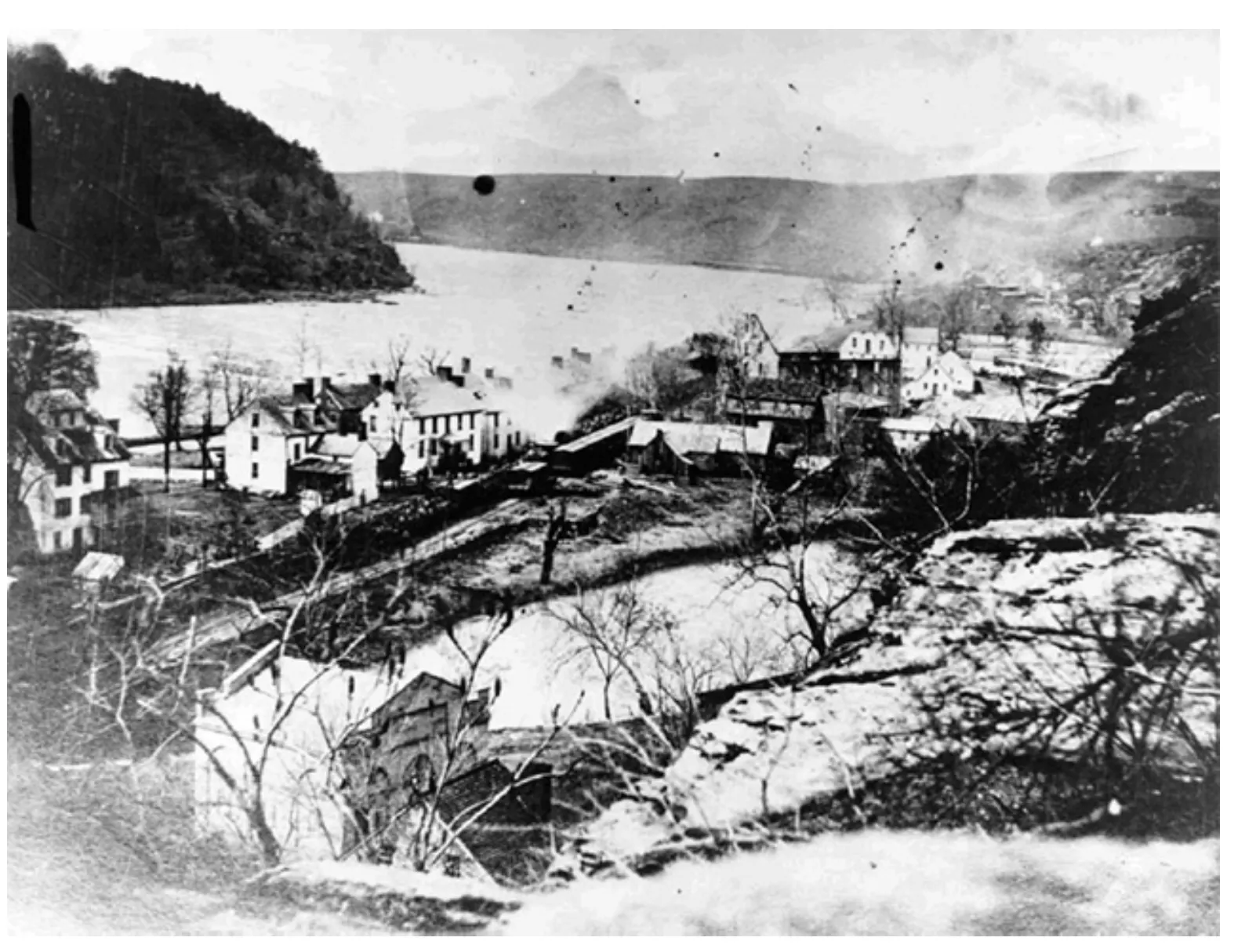 Stone ruins of mill buildings among trees beside the Shenandoah River on Virginius Island, Harpers Ferry, West Virginia