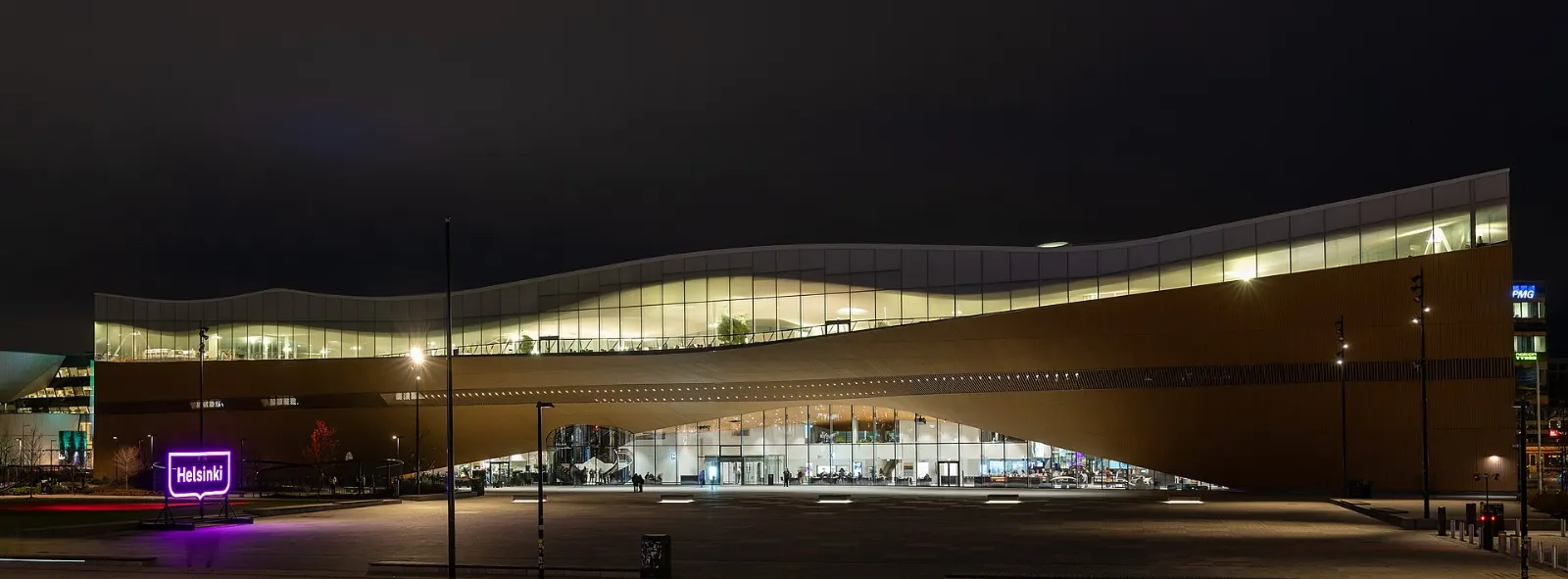 The curving wooden facade of the Oodi central library in Helsinki, Finland