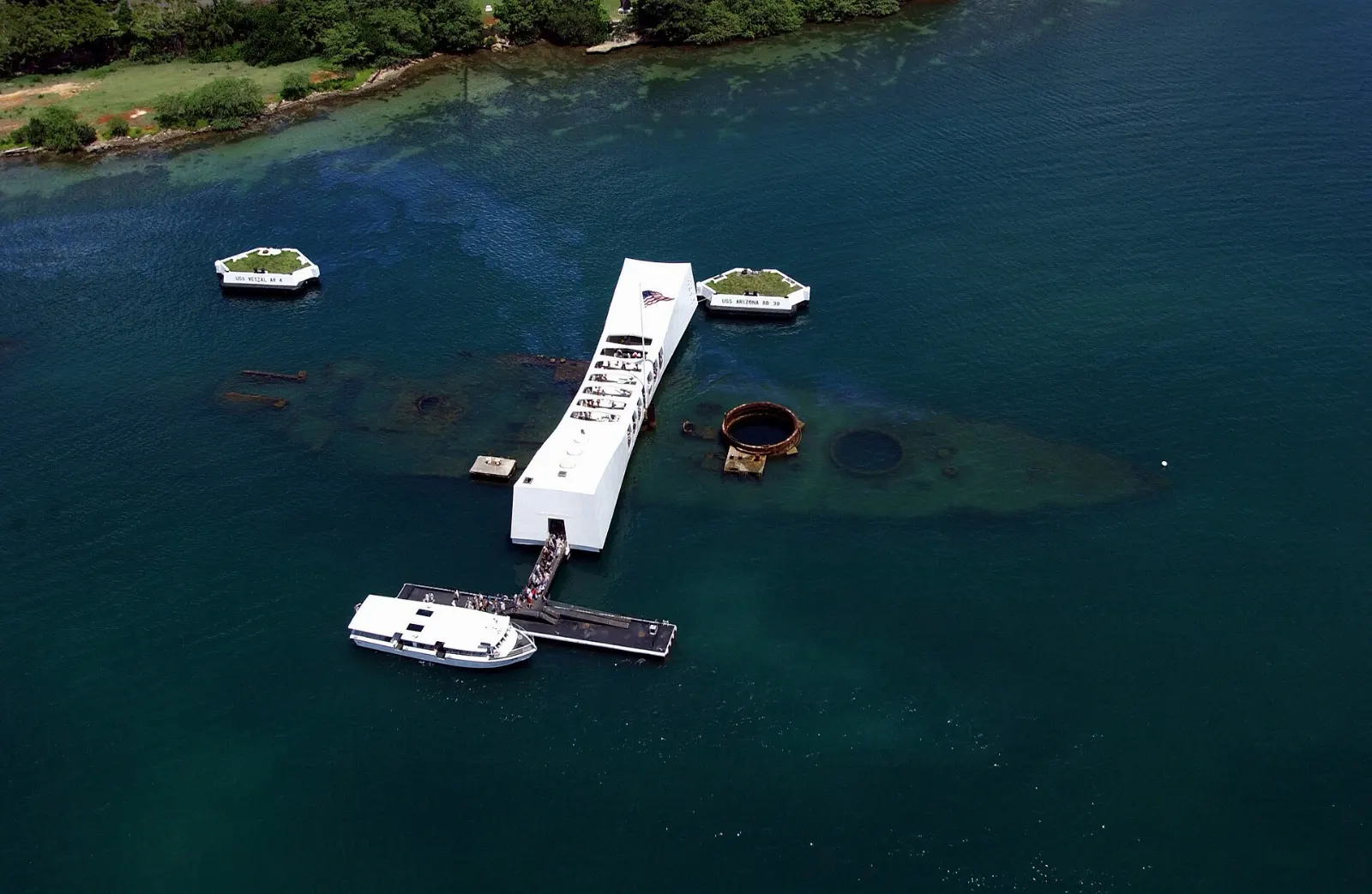 White USS Arizona Memorial structure spanning the sunken battleship in Pearl Harbor, Honolulu, Hawaii
