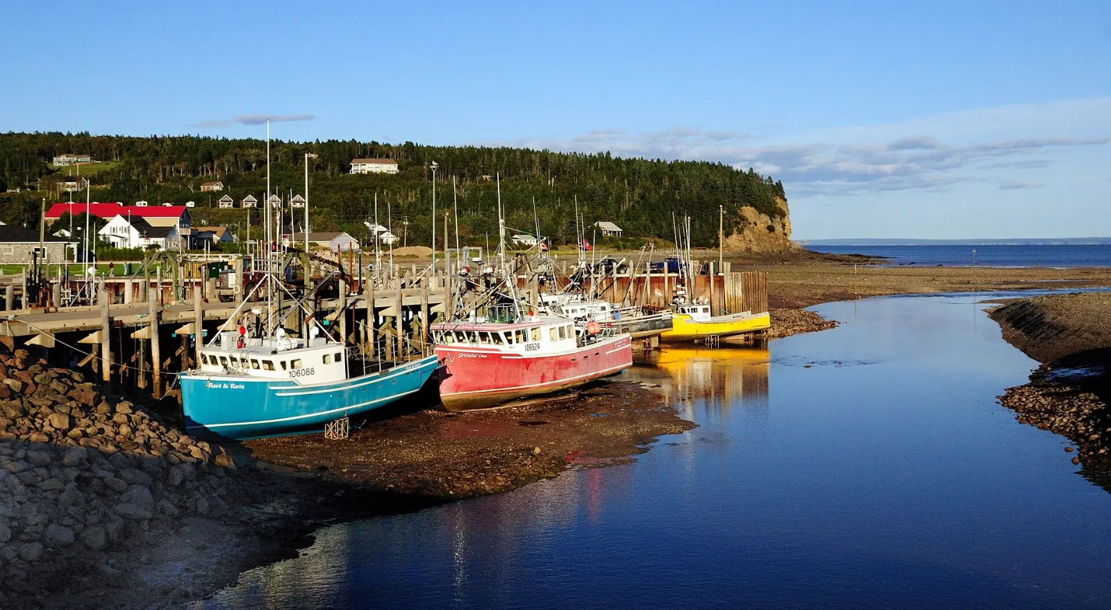 Fishing boats resting on the tidal flats of the harbour at Alma, Hopewell Rocks, New Brunswick