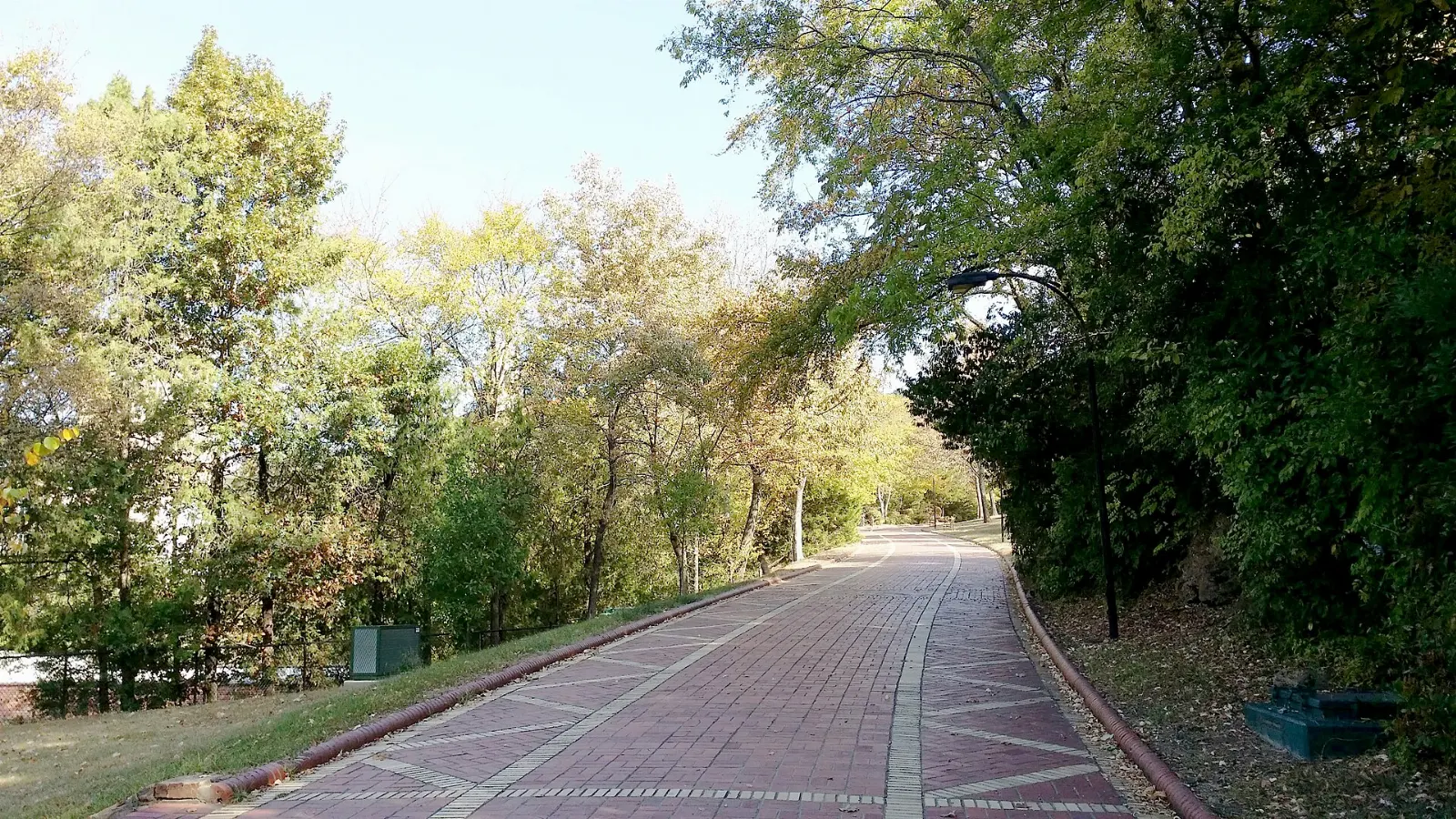 A brick walkway lined with trees behind the bathhouses of Hot Springs, Arkansas