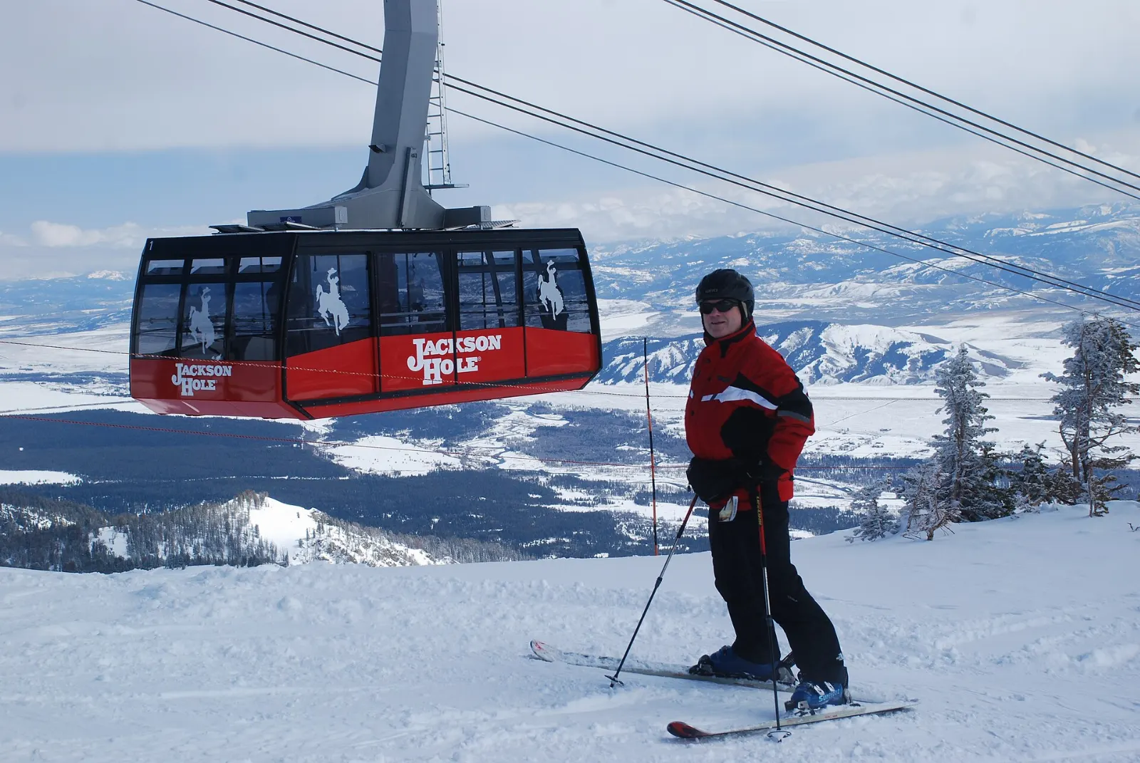 A red aerial tram cabin climbing toward Rendezvous Mountain, Jackson Hole, Wyoming