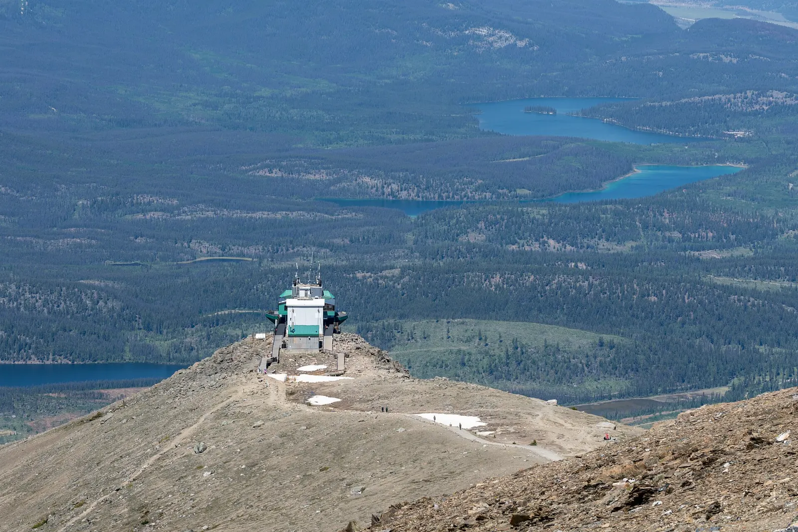 A cable car rising above forest on Whistlers Mountain with the Jasper valley below, Jasper National Park, Alberta
