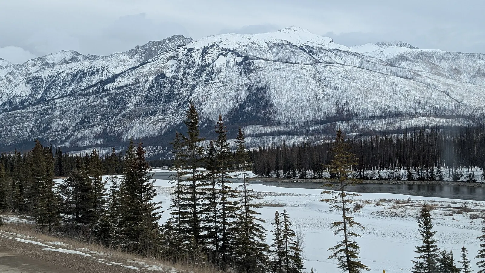 Medicine Lake with mountains rising behind its shallow water, Jasper National Park, Alberta