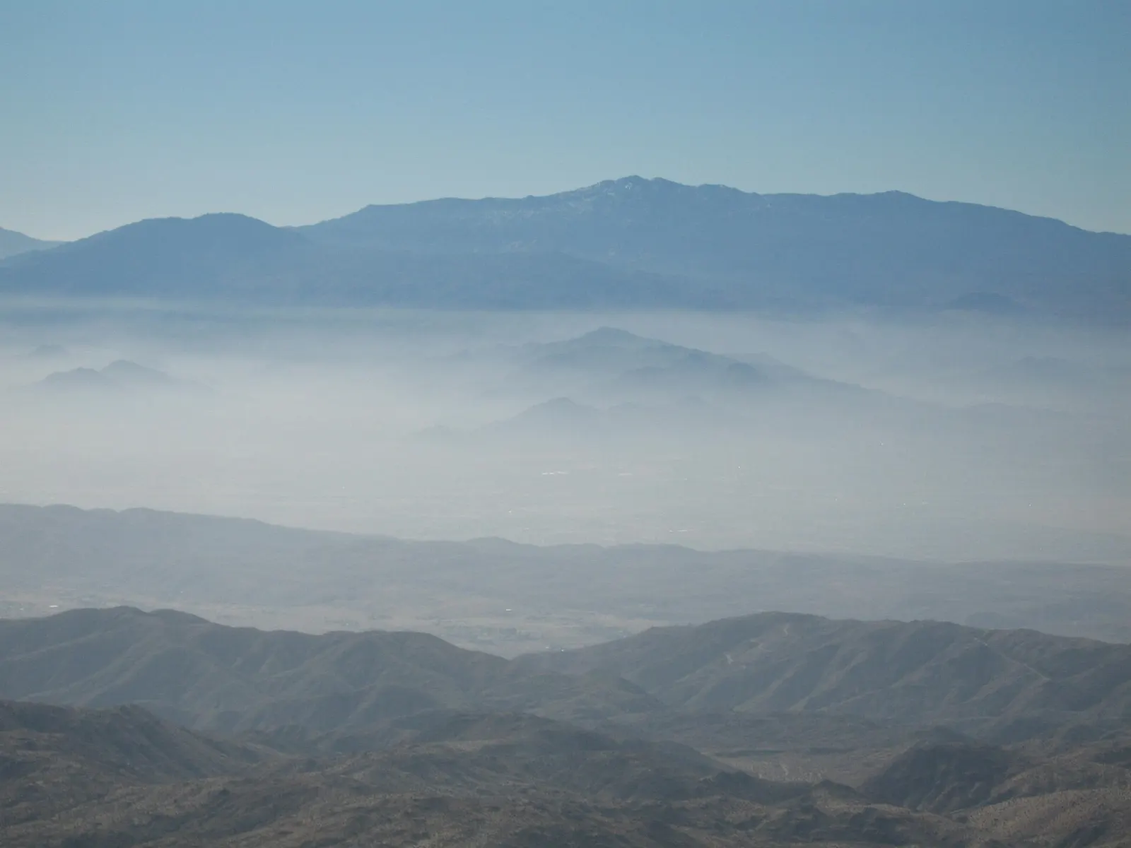 A wide view from a mountain overlook across the Coachella Valley toward distant peaks, Joshua Tree National Park, California