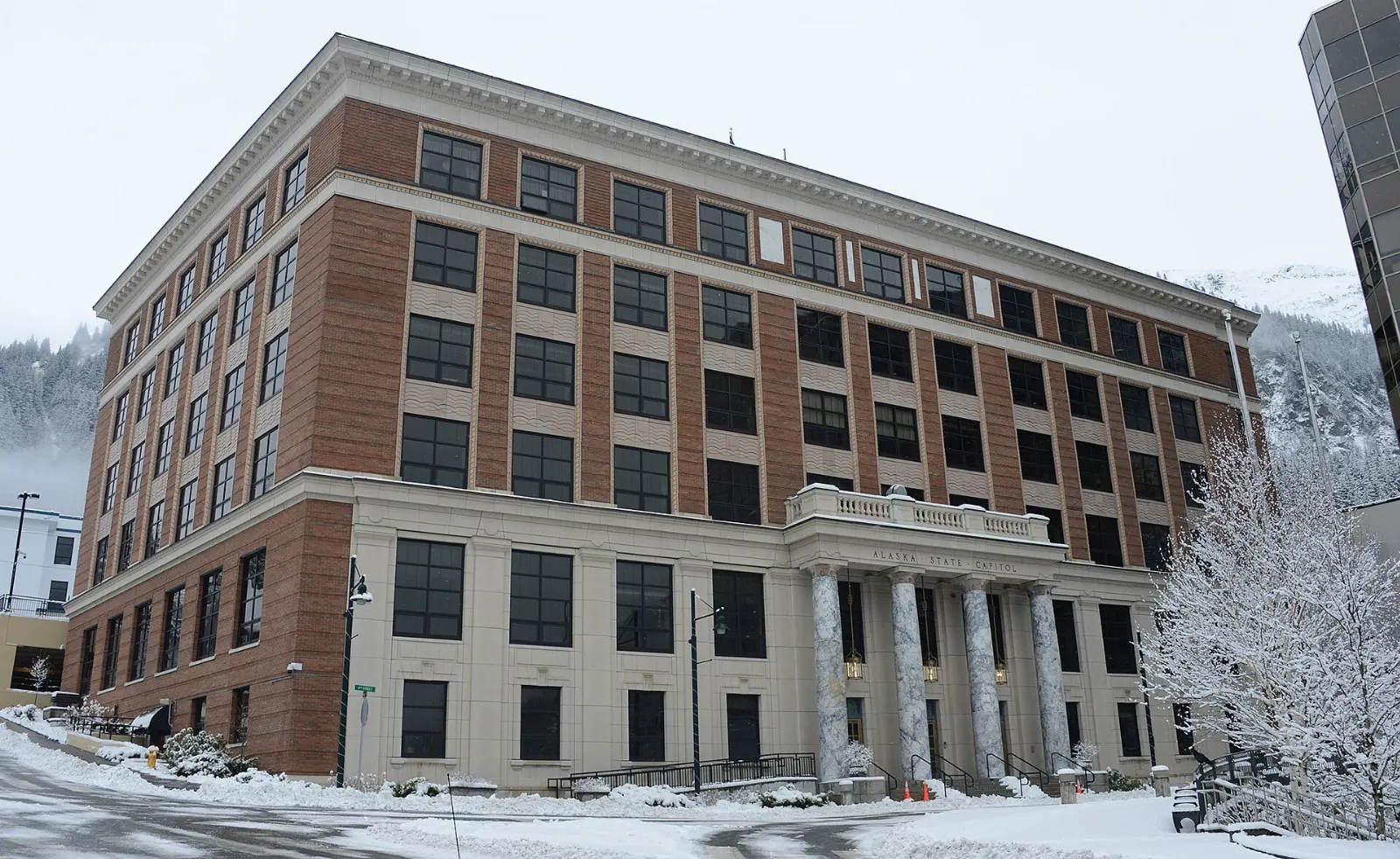 A brick and marble government building with columns on a downtown street, Juneau, Alaska