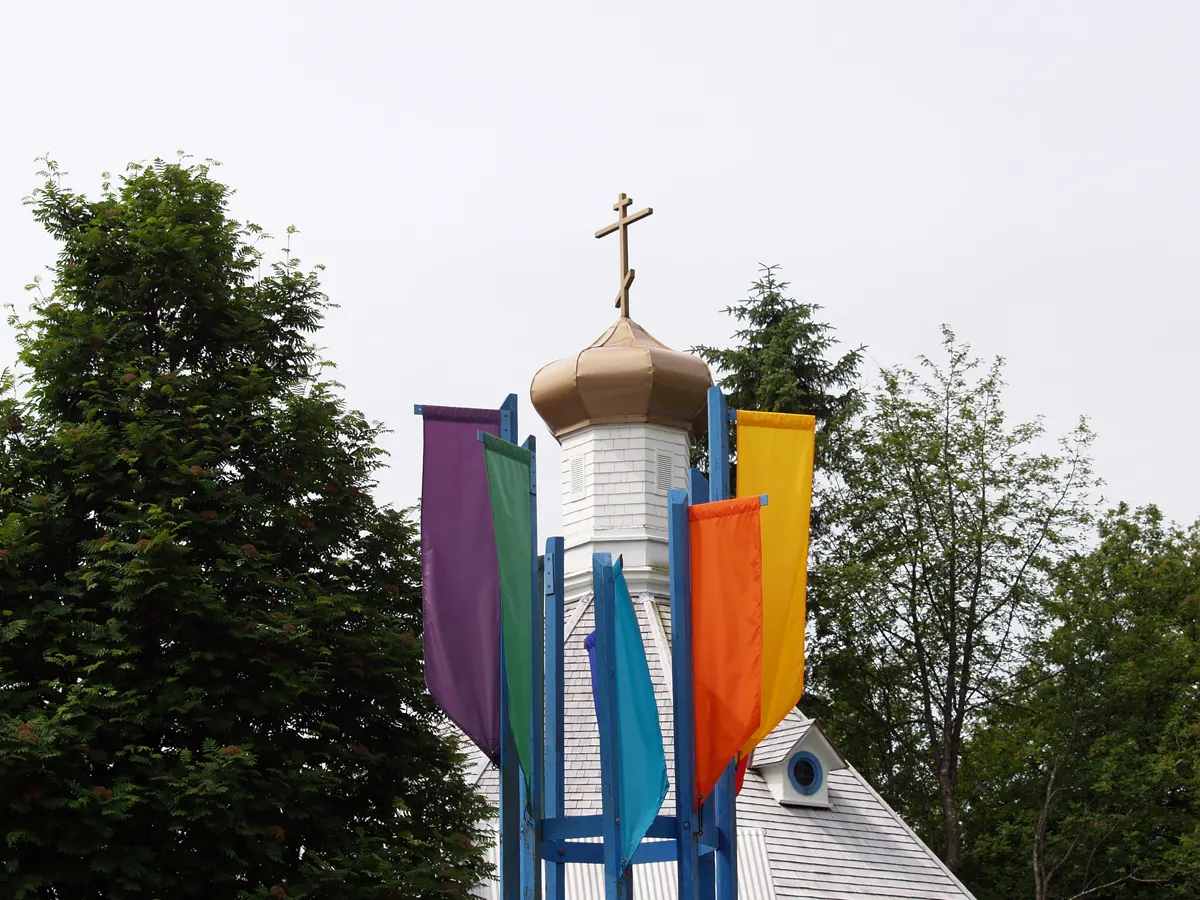 A small white octagonal church with an onion dome on a hillside street, Juneau, Alaska