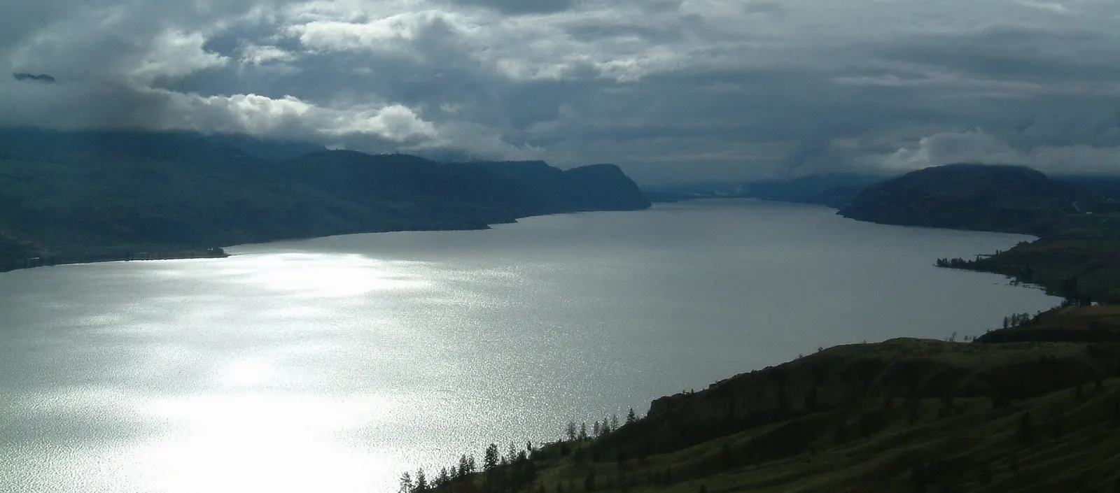 Kamloops Lake with steep dry hillsides along its shore, British Columbia