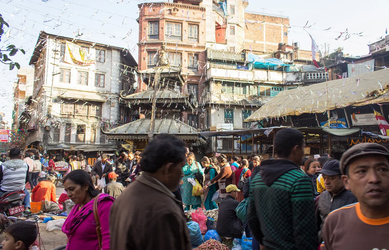 A busy market square with a small pagoda temple in Asan, Kathmandu, Nepal