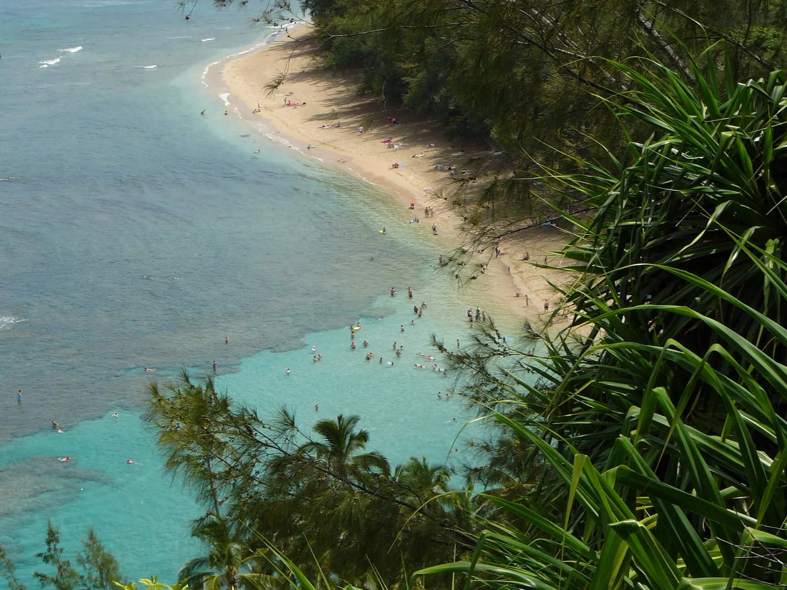 Calm reef lagoon at Kee Beach with green cliffs rising beyond, Kauai, Hawaii