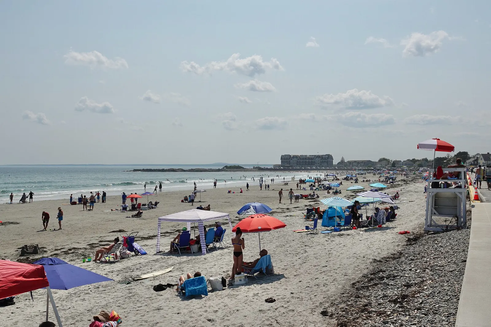 Wide sandy crescent of Gooch's Beach with shingled houses behind it, Kennebunkport, Maine