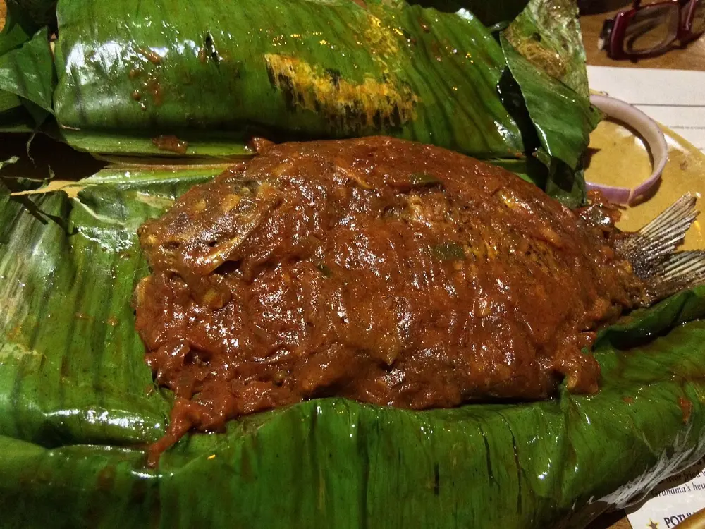 Karimeen pollichathu in Kerala Backwaters, India