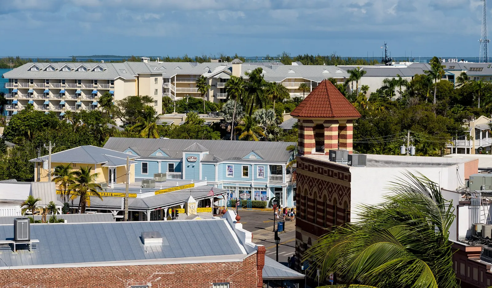 Pastel storefronts, balconies and palm trees along Duval Street, Key West, Florida