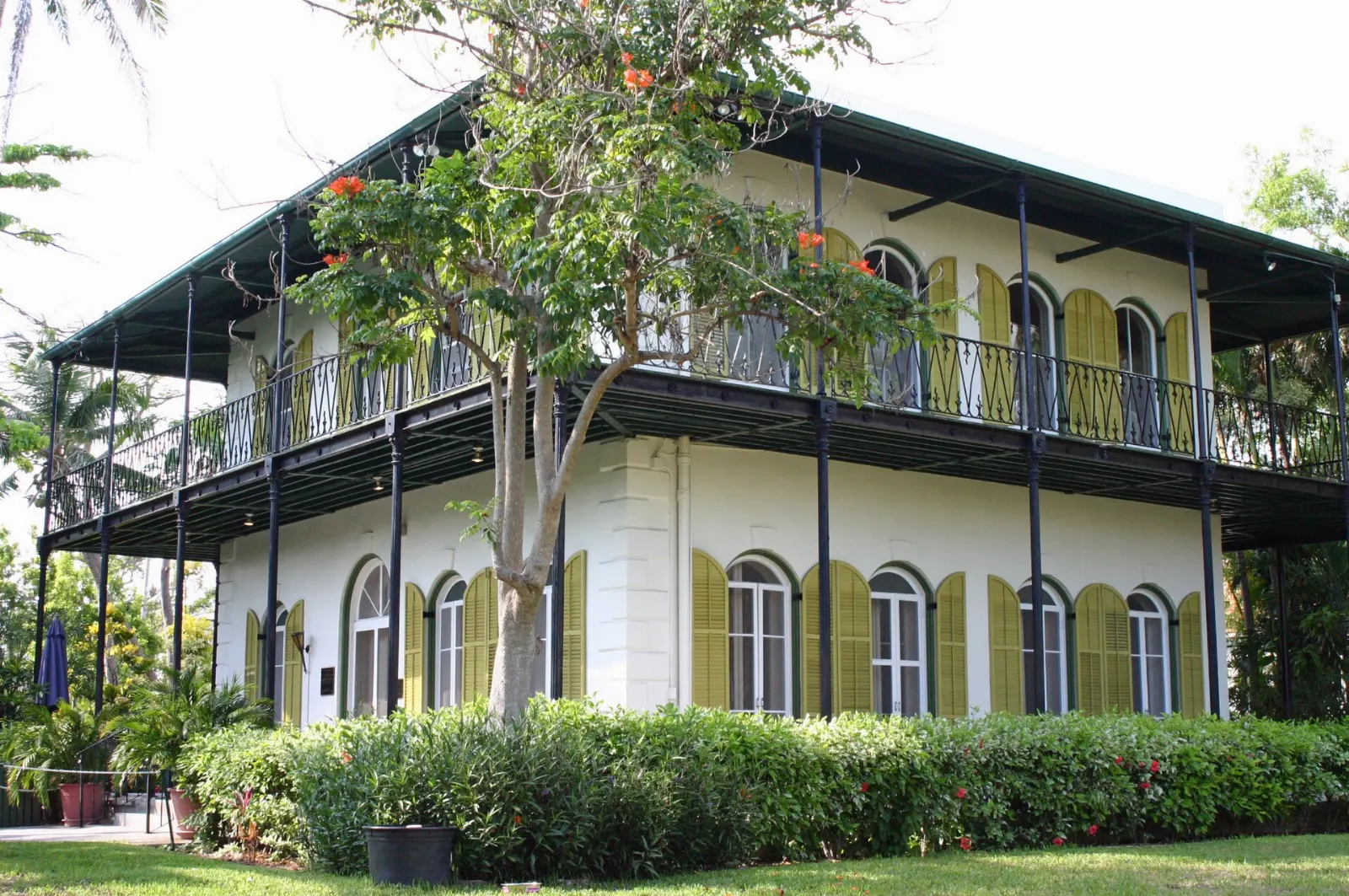 Yellow-shuttered Spanish Colonial house of the Ernest Hemingway Home among tropical gardens, Key West, Florida
