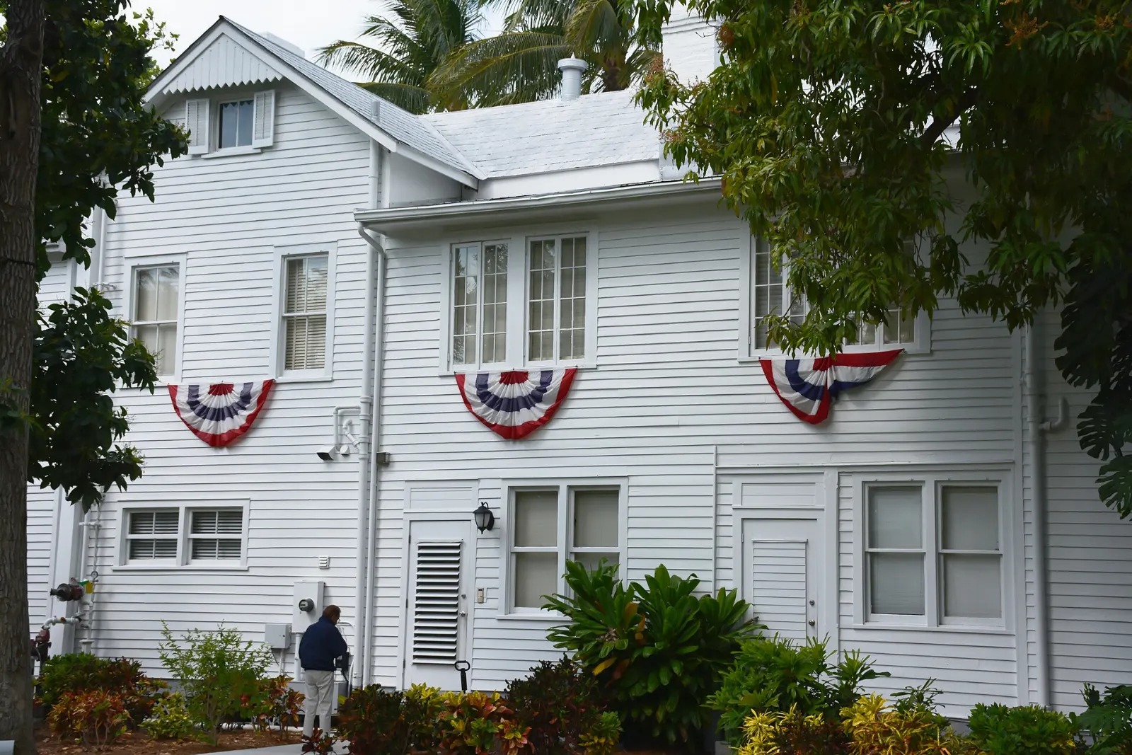 White wooden Little White House with green shutters in the Truman Annex, Key West, Florida