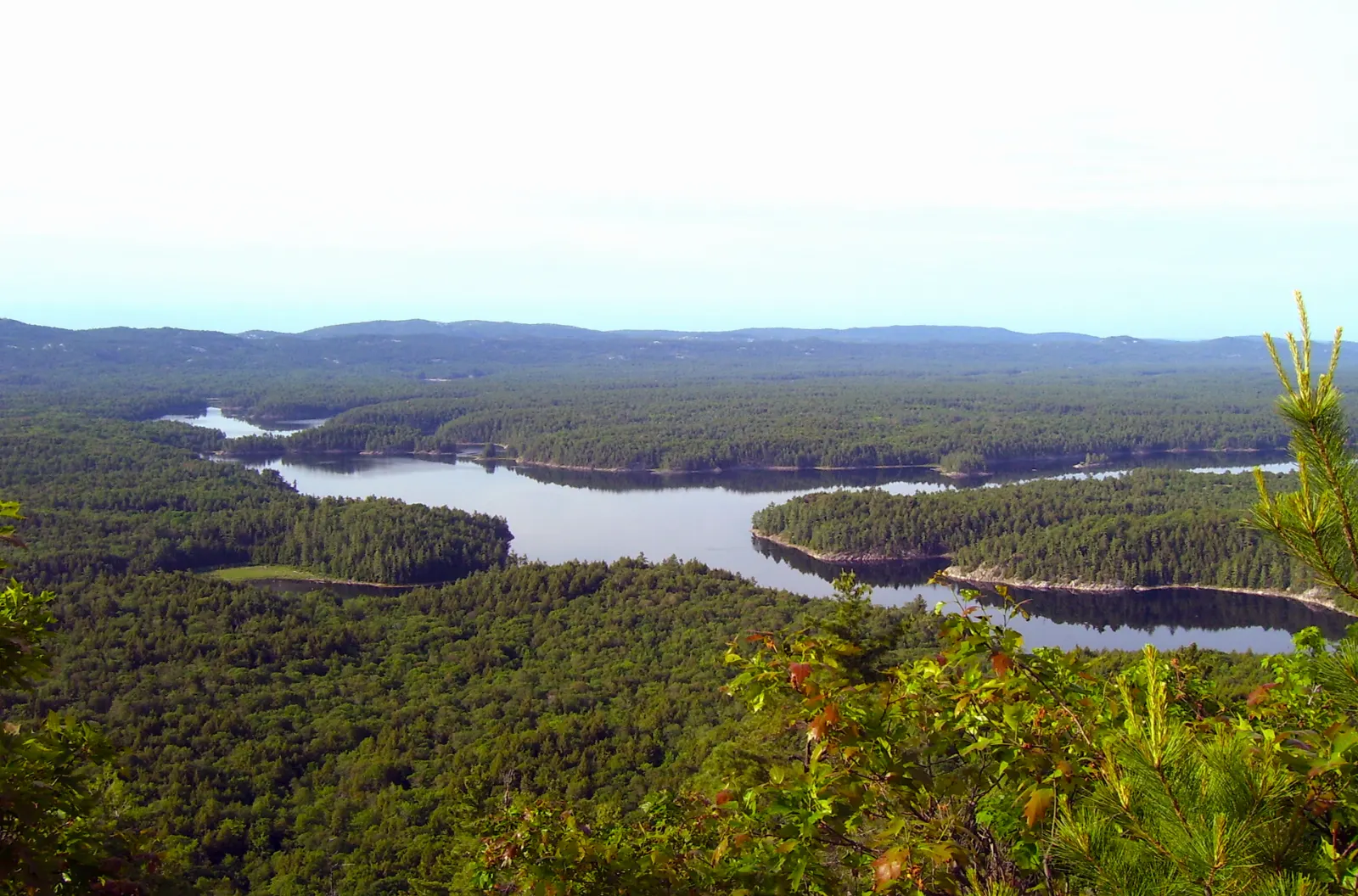 Hiker on a white quartzite ridge on the La Cloche Silhouette Trail, Killarney Provincial Park, Ontario