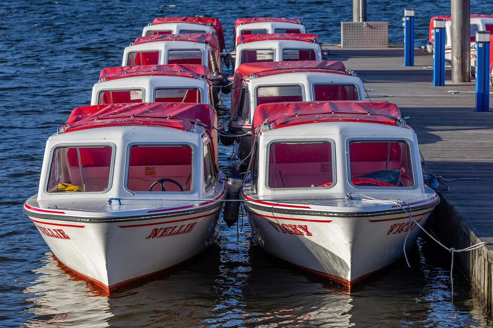Rowing boats and lake cruisers moored at the piers in Bowness-on-Windermere, Lake District, England