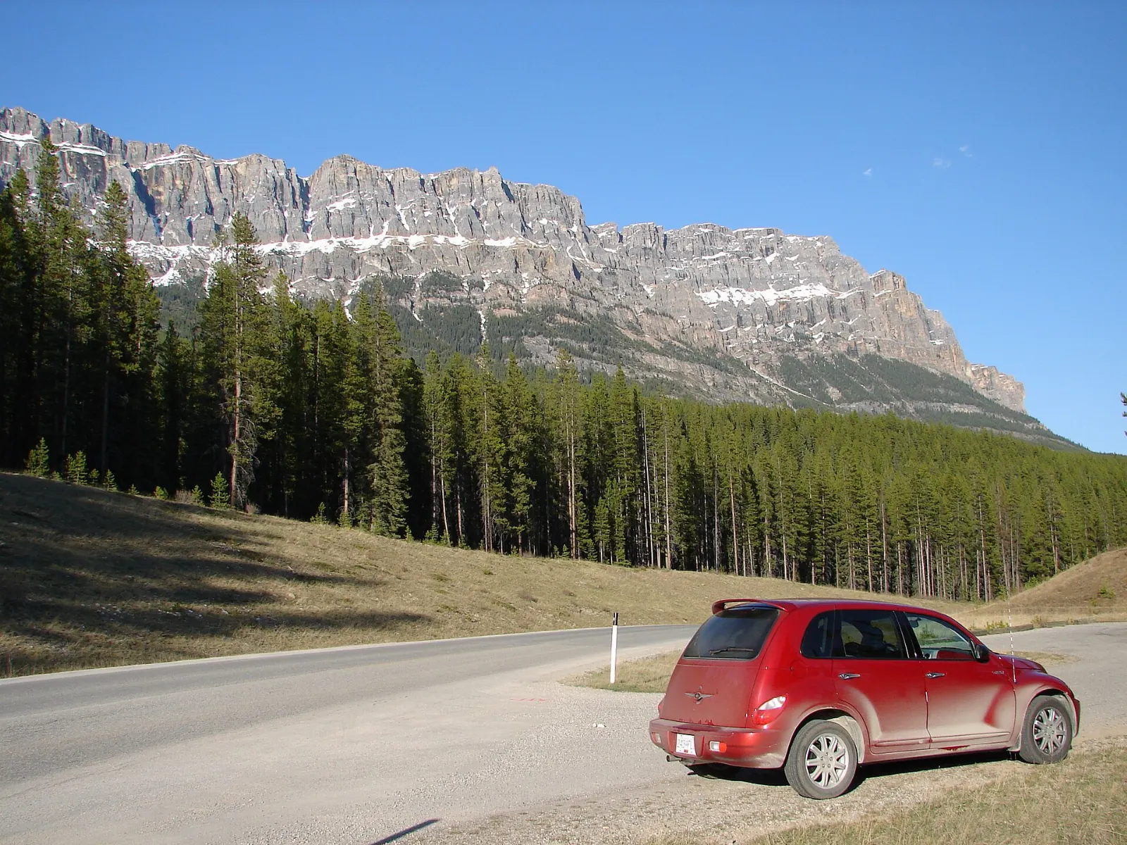 A quiet road winding through forest along the Bow Valley Parkway, Lake Louise, Alberta