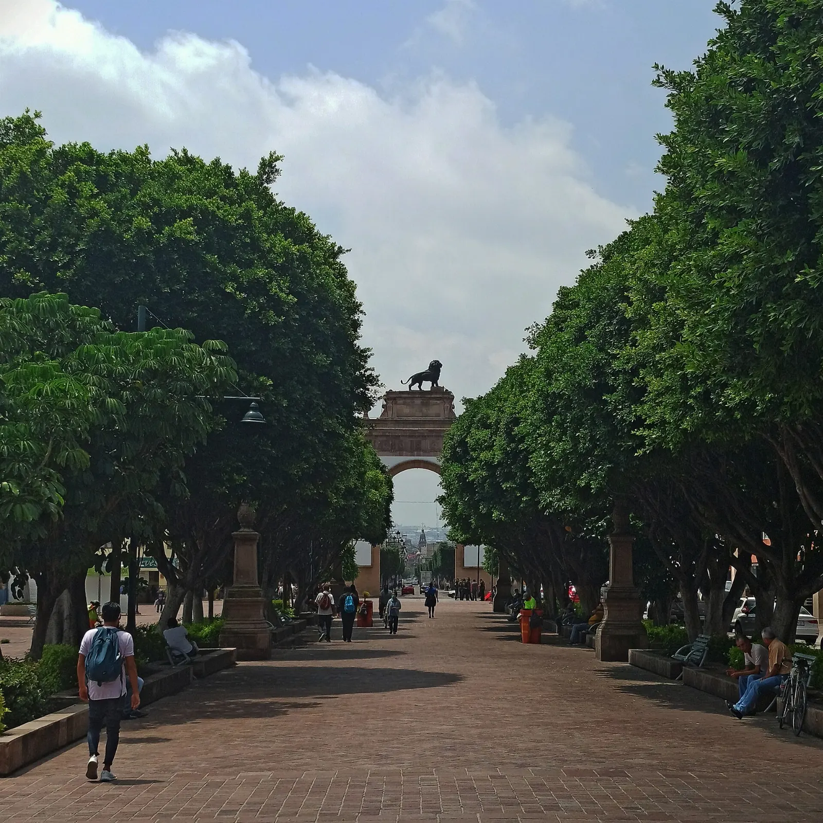 The neoclassic Triumphal Arch crowned by a bronze lion on the Calzada de los Héroes, León, Guanajuato