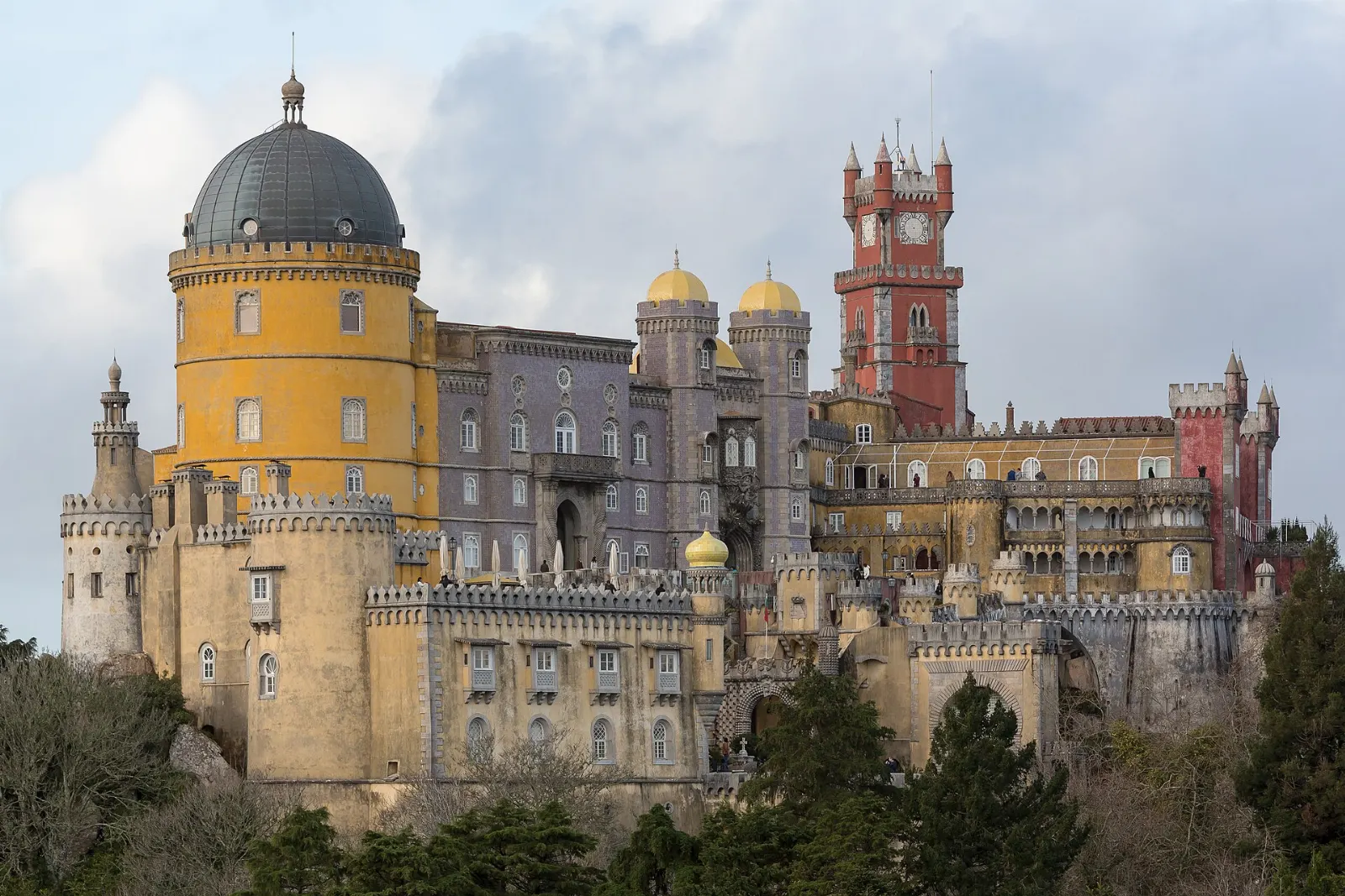 The colourful towers of Pena Palace on a forested hilltop in Sintra, Lisbon, Portugal