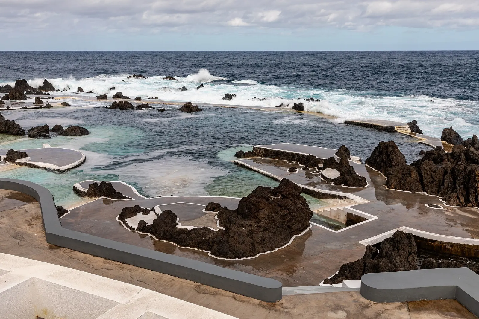 Seawater pools formed in black volcanic rock beside the ocean, Madeira, Portugal
