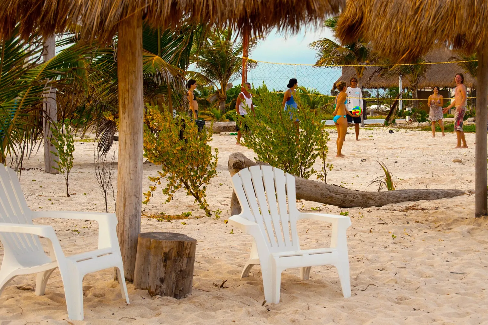 Thatched palapas and beach chairs along the shore at Mahahual, Quintana Roo