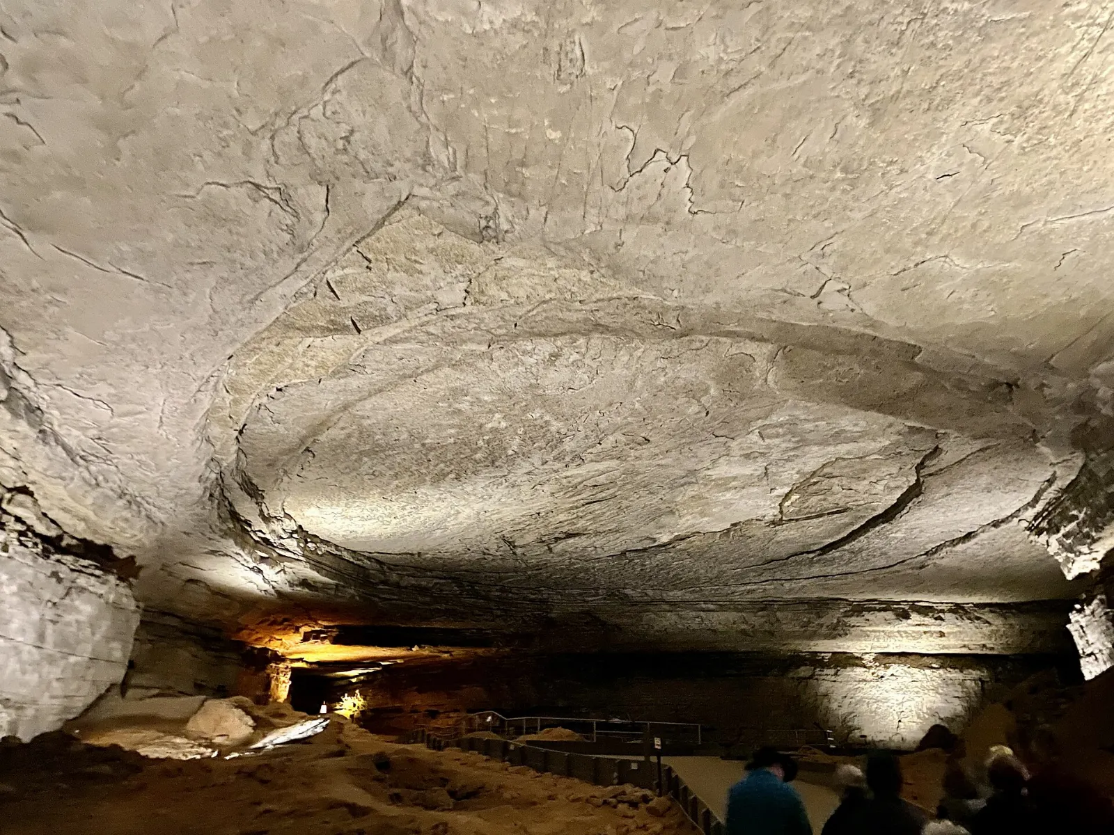 A wide, dimly lit cave chamber with old wooden saltpeter mining equipment, Mammoth Cave National Park, Kentucky