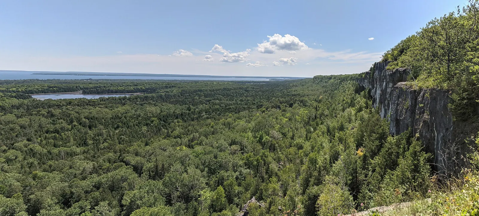 Cliff lookout on the Cup and Saucer Trail over farmland and Lake Huron, Manitoulin Island, Ontario