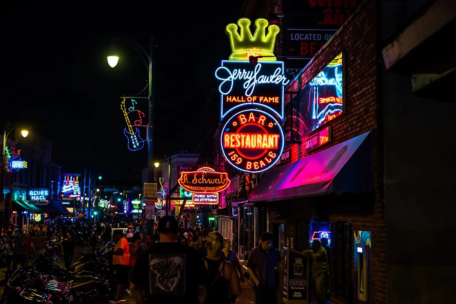 Neon signs of blues clubs lighting up Beale Street at night, Memphis, Tennessee