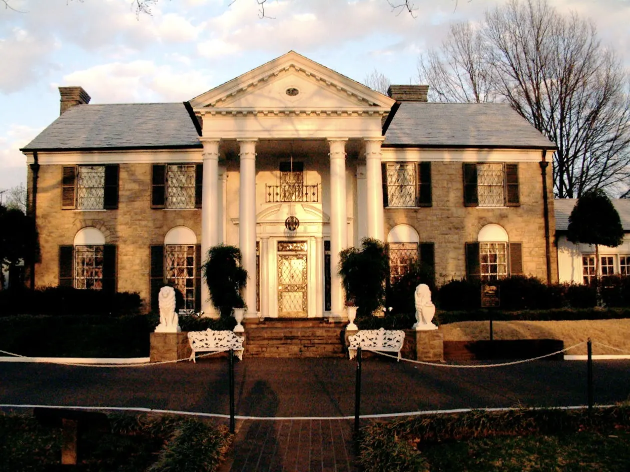 White columned front of the Graceland mansion behind a green lawn, Memphis, Tennessee