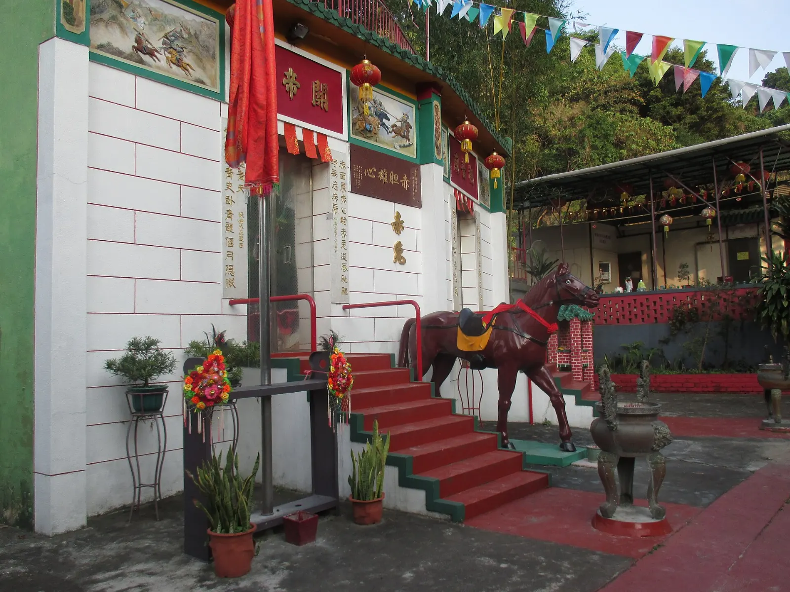 A small red and green wooden temple on Albion Street in Mendocino, California
