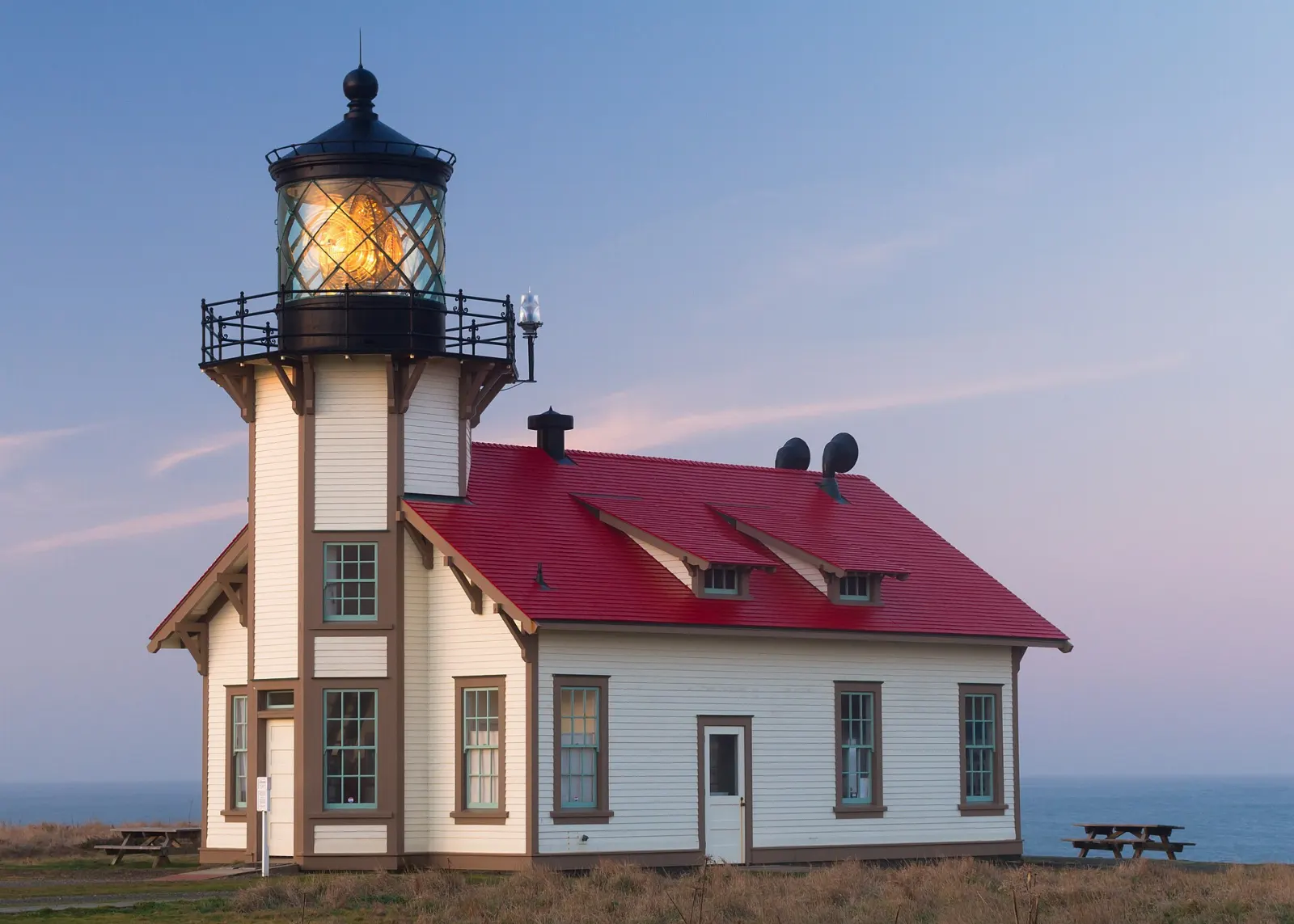 A white lighthouse with a red roof on the bluffs at Point Cabrillo, Mendocino, California