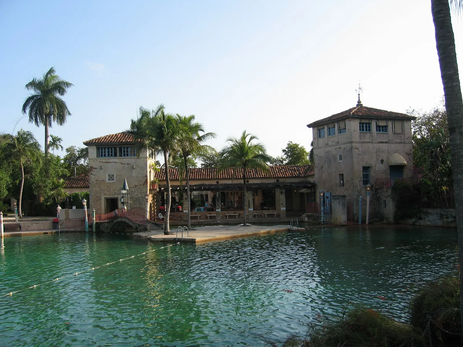 Historic swimming pool with coral rock grottoes, bridges and palm trees, Miami, Florida
