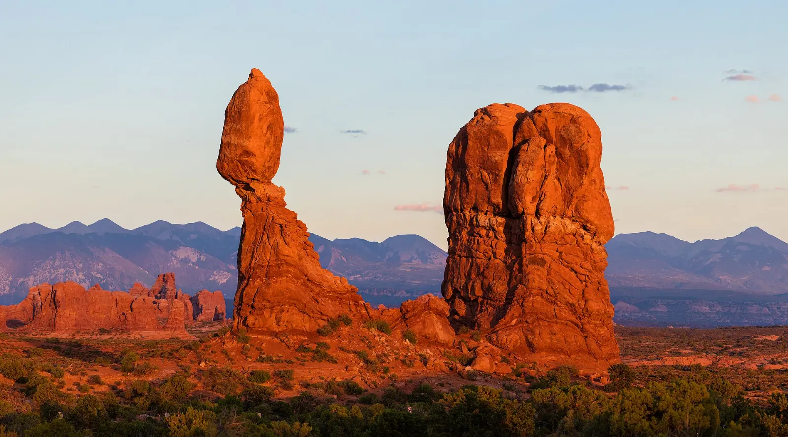 A large boulder perched on a narrow rock pedestal in Arches National Park, Moab, Utah