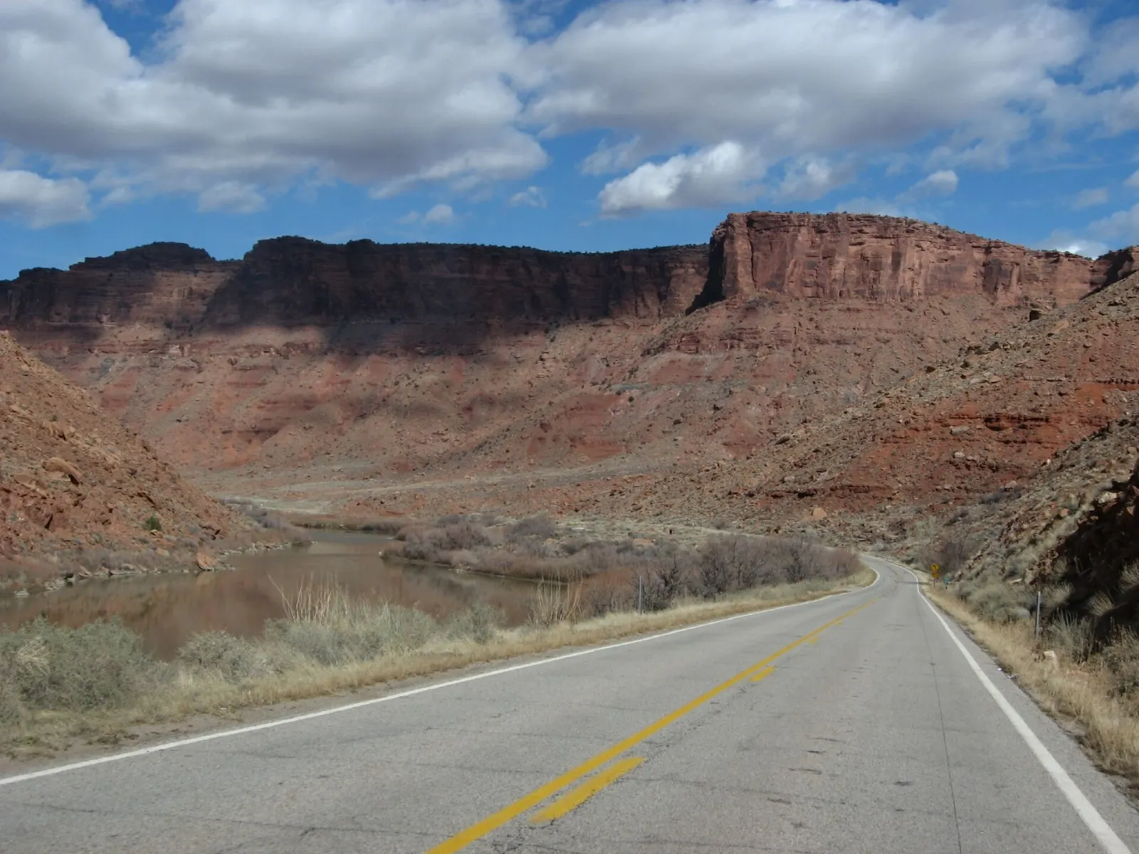 The Colorado River curving between red cliffs along Scenic Byway 128, Moab, Utah
