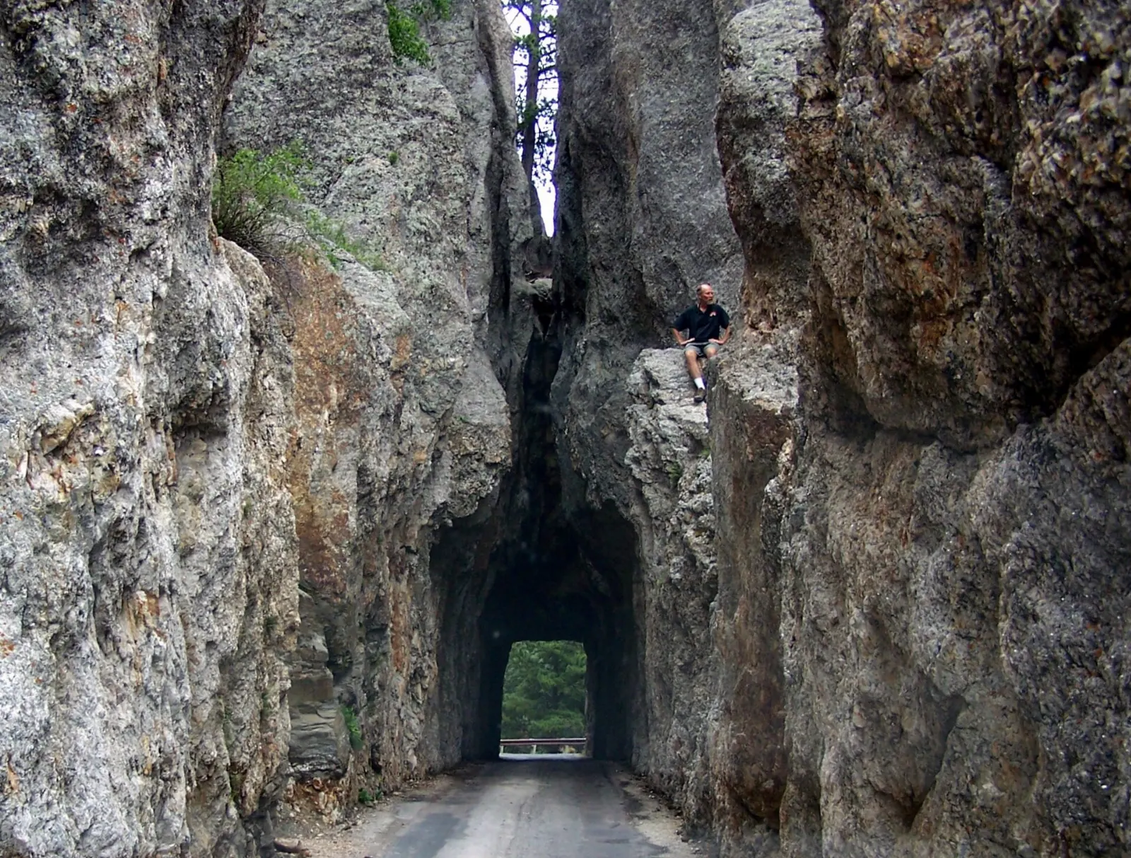 A narrow one-lane tunnel cut through granite spires on the Needles Highway, Mount Rushmore and the Black Hills, South Dakota