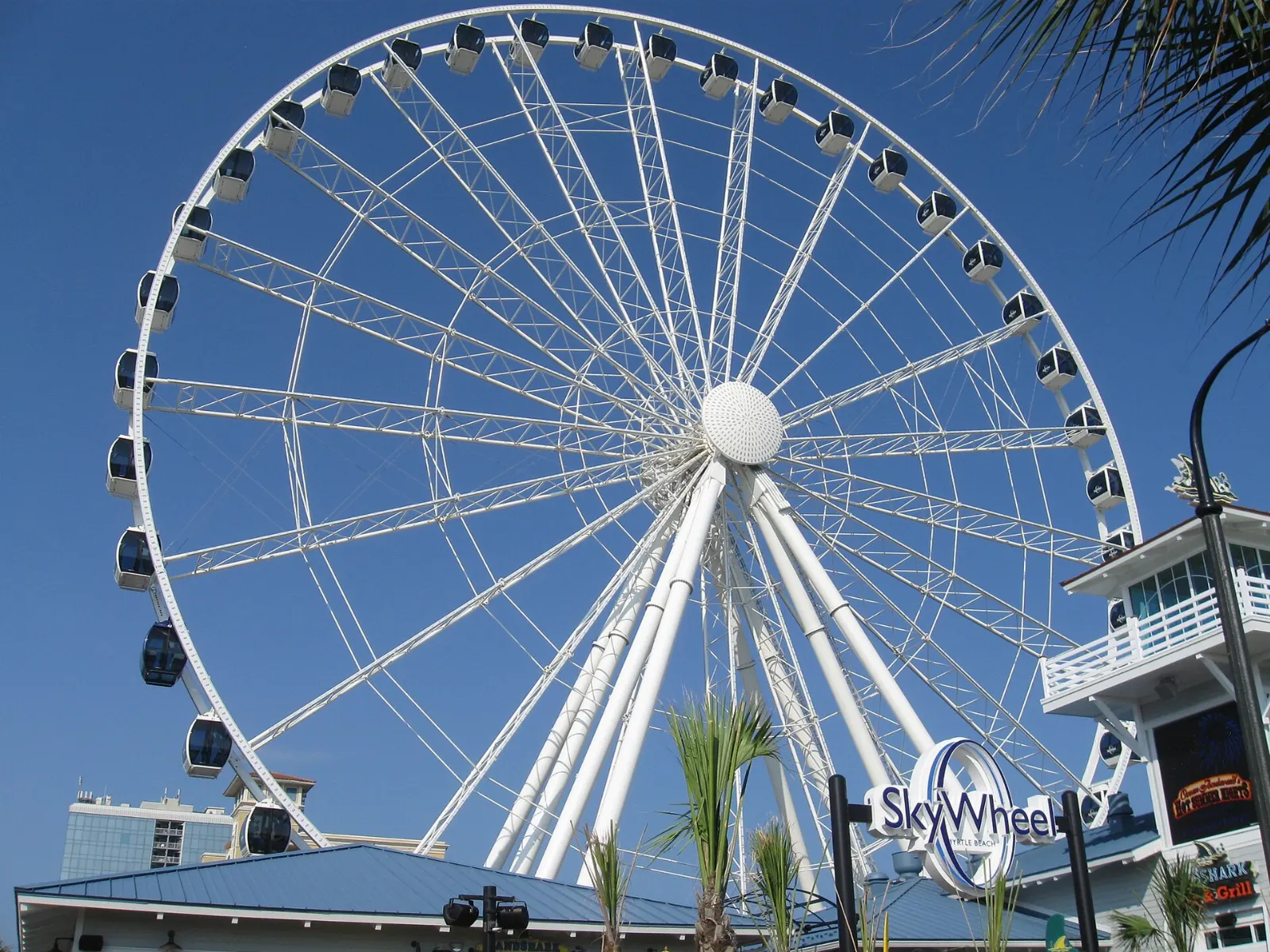 The Myrtle Beach SkyWheel with its enclosed gondolas against a blue sky, South Carolina